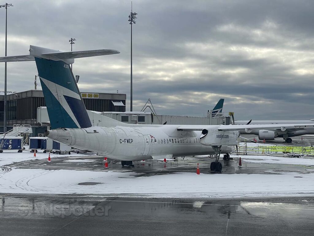 WestJet Dash 8 parked at the terminal YVR